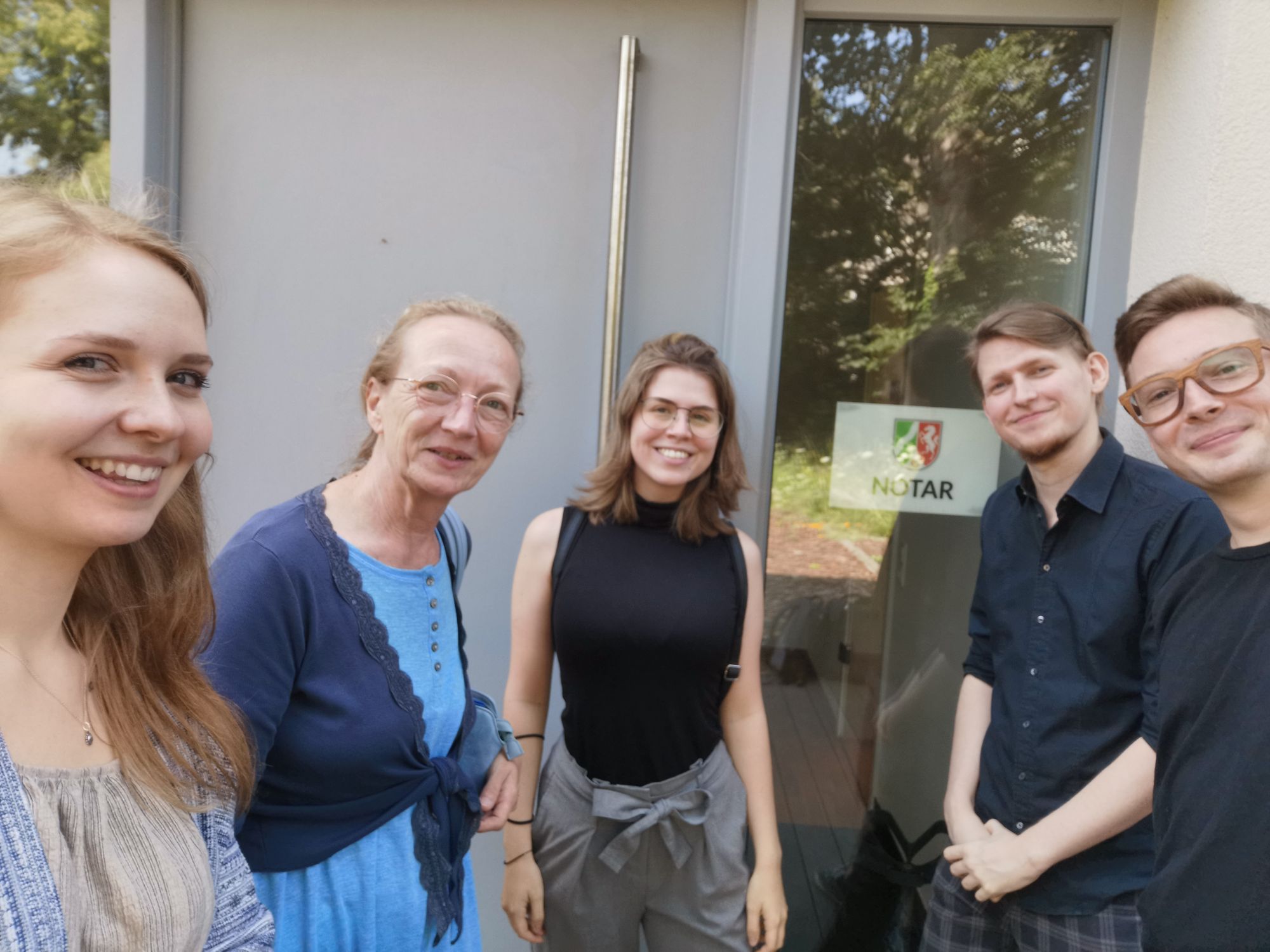 The spoonful games team standing infront of the notary building after founding the company, smiling widely into the camera.